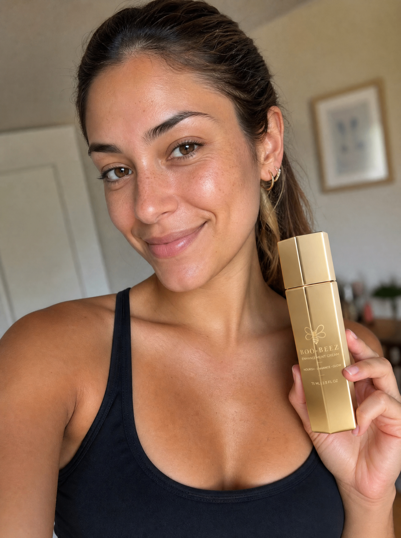 Isabela Moreno, verified Boo-Beez customer, holding Enhancement Cream