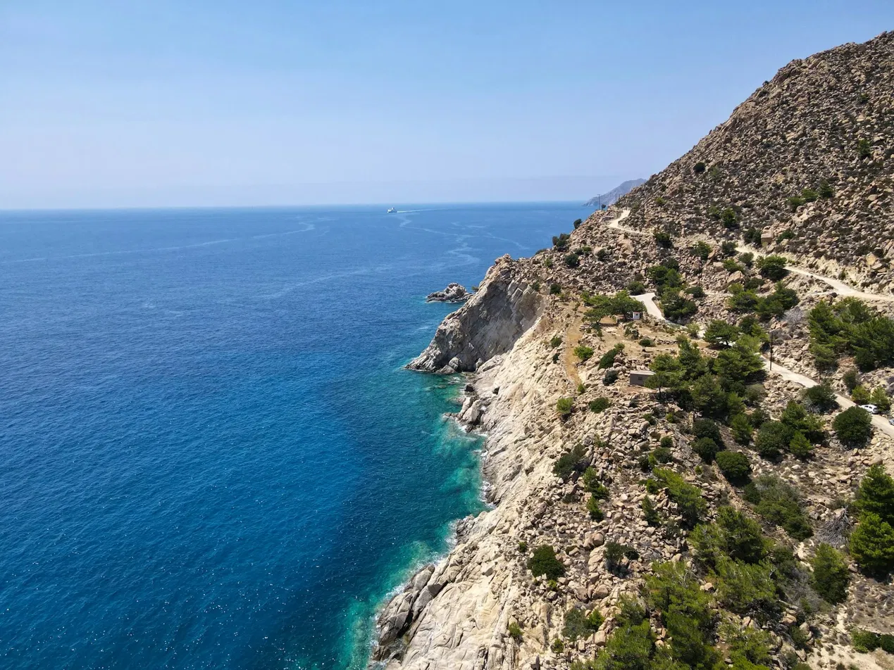 Aerial view of Ikaria's rugged cliffs above the Aegean Sea